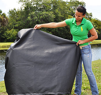 Woman adjusting a cover for a scooter